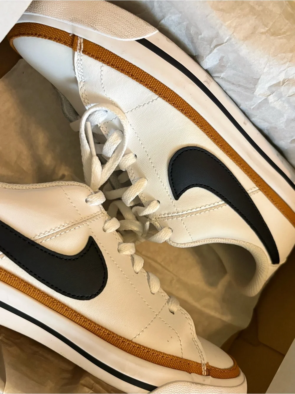 Nike White Sneakers with Black Swoosh and Gold Trim